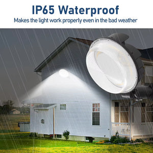 IP65-rated LED barn light illuminating a building exterior in rainy weather