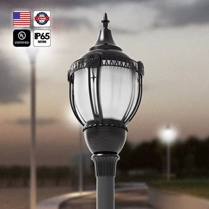 High-output decorative LED acorn post top light installed outdoors at dusk